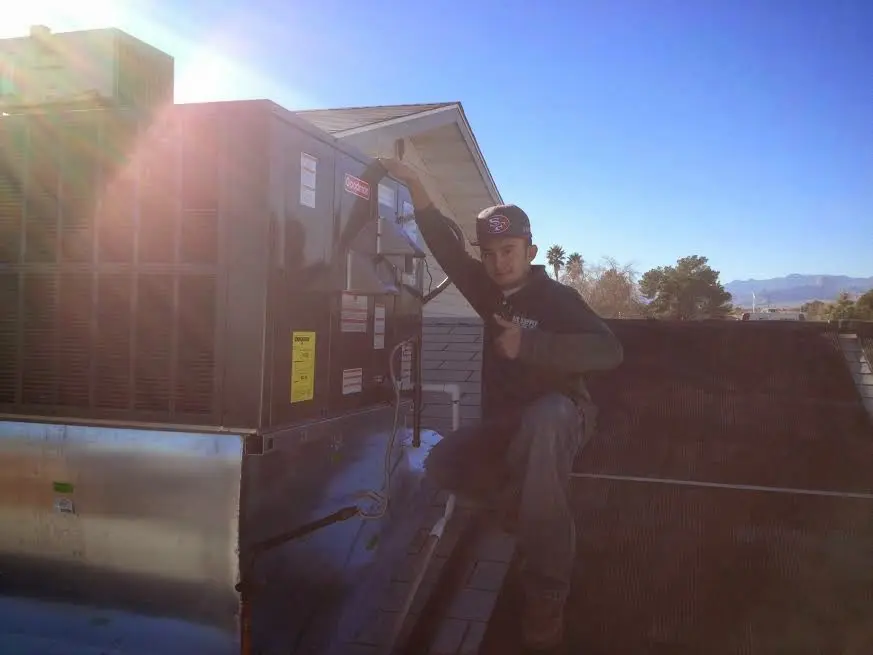 HVAC technician performing Boiler Repair on a rooftop unit in Hillsborough